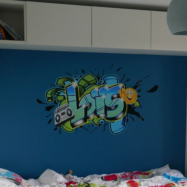 Sticker géant graffiti prénom Loïs découpé sur mur bleu de chambre d'enfant